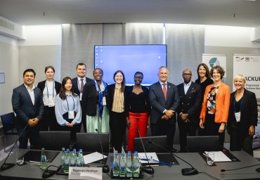 A group of people taking a picture with a graphic illustration behind them